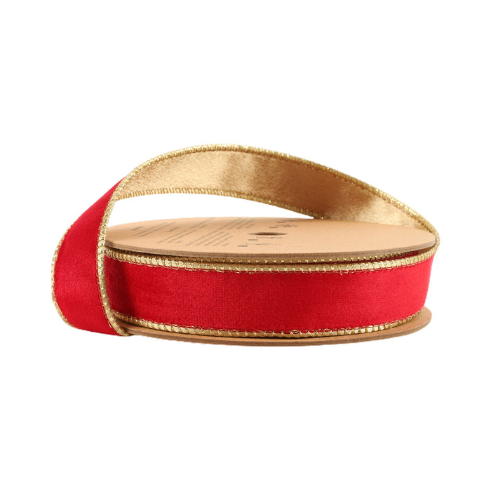 A spool of 1" Red and Gold Reversible Classic Velvet Ribbon (7115W-250-25E), partially unrolled, rests on its side against a white background.