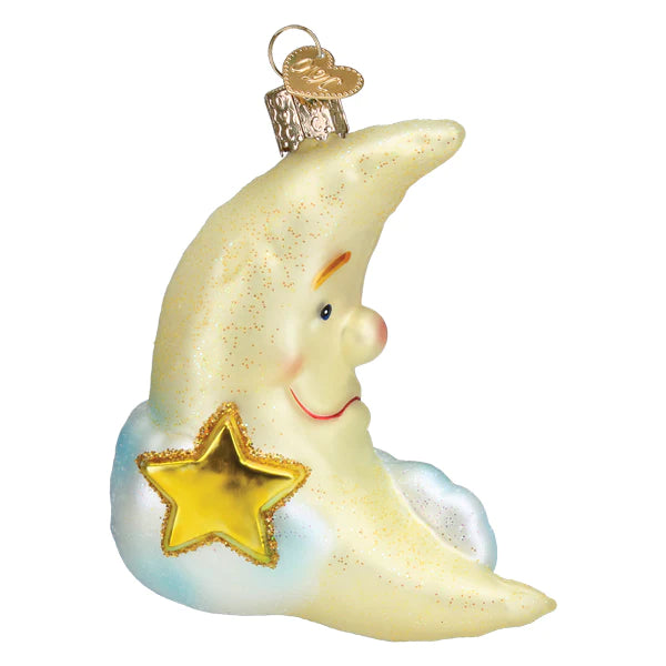 The Mister Moon Ornament by Old World Christmas (22047) features a crescent moon with a smiling face, gold glitter, yellow star, and blue cloud base. A gold cap and hook at the top make it easy to hang.