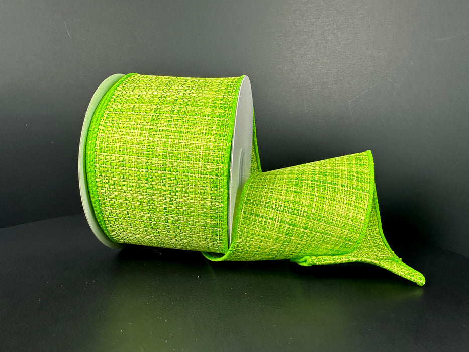 A partially unspooled roll of 2.5X10Y Lime Tweed Solid Ribbon 41512-40-09 stands out against a dark background, with its textured, wired design maintaining a cylindrical shape for added vibrancy and structure.