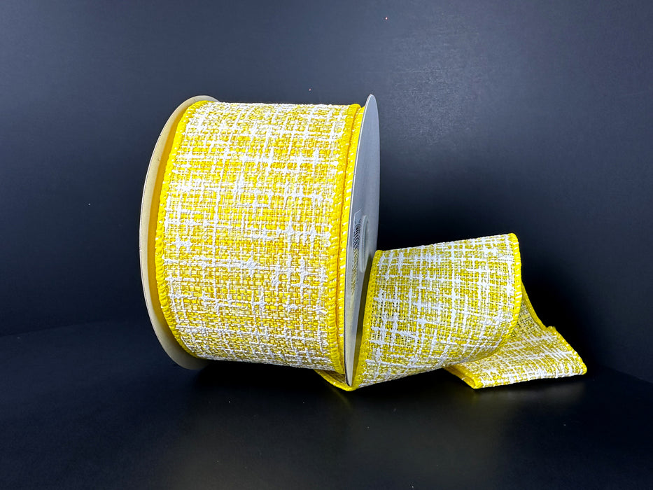 A partially unfurled 2.5X10Y Yellow-White Embellished Tweed Ribbon appears against a dark background, showcasing its textured pattern and bright yellow grid-like design, perfect for adding elegance to any project.