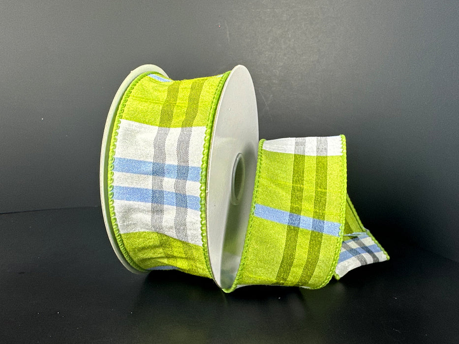 The 1.5X10Y Kiwi Iris White Ayanna Dupioni Plaid Ribbon unfurls gracefully in green, blue, white, and gray against a plain black background.