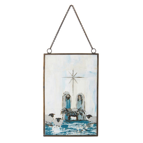 The 6" Holy Family Ornament 4312526 is a rectangular framed artwork hanging by a chain, showing Mary, Joseph, and baby Jesus in a manger with animals and a star above, painted in blue, white, and brown as an elegant religious decoration.
