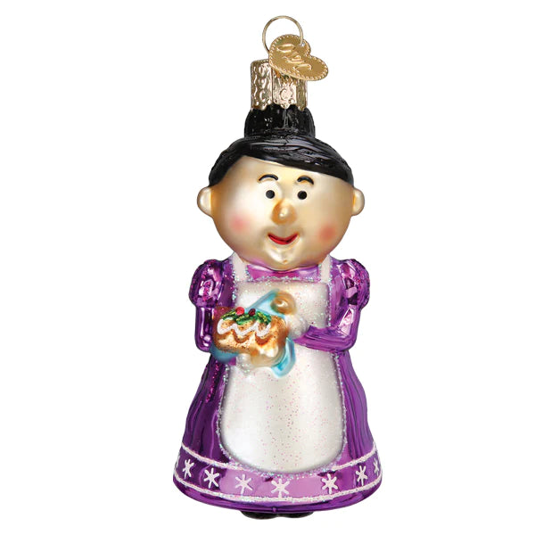 The Cheery Mrs Claus Old World Christmas Ornament 44209 features a smiling woman with black hair in a bun, wearing a purple dress and white apron while holding a small decorated cake.
