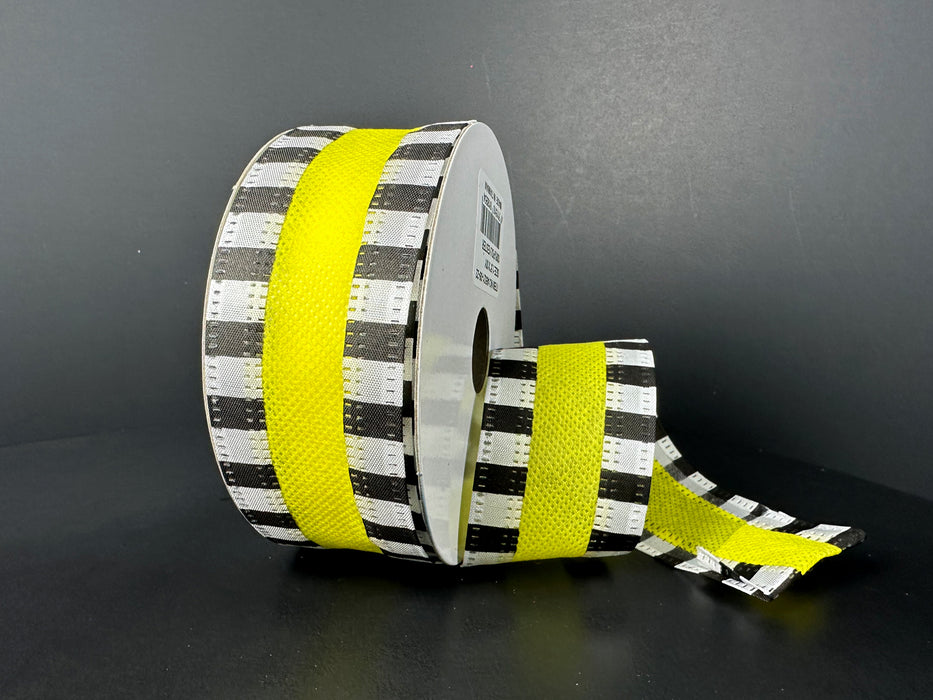 A roll of 1.5X10Y Yellow Flat Breeze/Black And White Stripe Edge Ribbon, partially unrolled on a dark surface against a plain dark background.