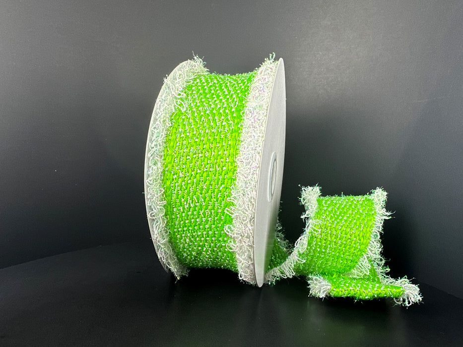 A large spool of 2.5X 5Y Lime Iridescent Loopy Edge Ribbon (47509-40-09) stands upright on a black surface with a shorter piece beside it, highlighting its textured feel and unique frayed white edges.
