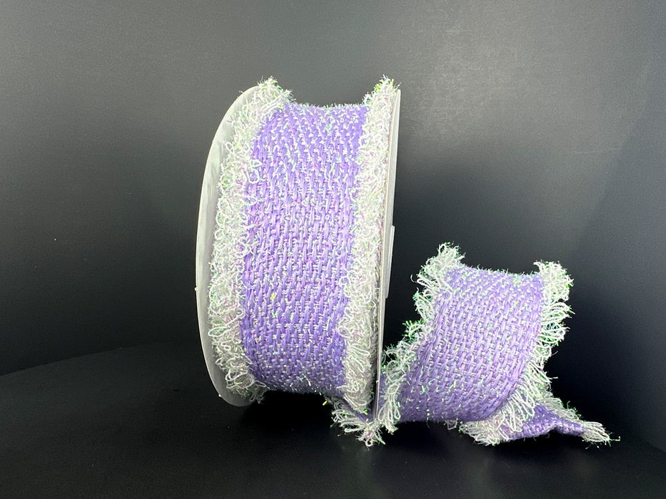 Against a black background, the 2.5X 5Y Lavender Iridescent Loopy Edge Ribbon (47509-40-30) is shown with frayed edges: one larger spool stands upright while the smaller lies beside it, displaying its soft woven texture.