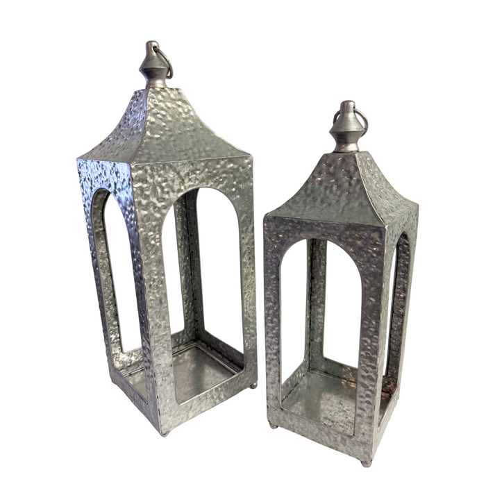 Illuminate any space with this set of two hammered silver artisan lanterns (19x7 and 16x5, 570600AB), expertly crafted with timeless design and perfect for adding a warm, inviting glow.