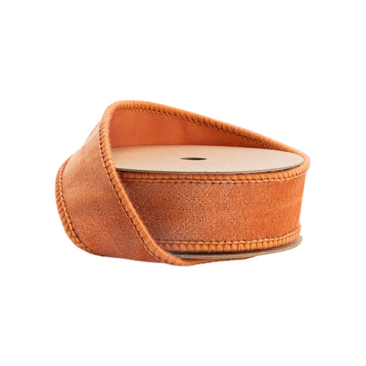 A partially unrolled spool of 1" Orange Velour Ribbon 7126W-780-25E with stitched edges is shown against a white background.