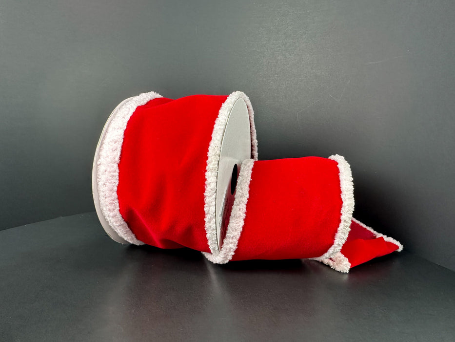 A 2.5 x 10 yd Red Velvet White Super Fuzz Edge Ribbon (72522-40-13), with fluffy trim reminiscent of Santa’s suit, lies on its side against a dark gray background.