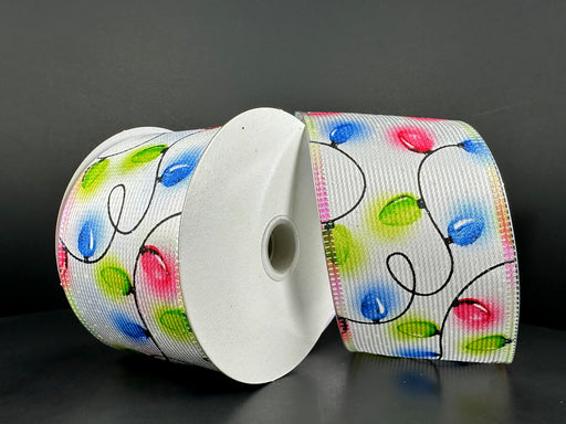 Two rolls of 2.5x10Y white textured satin ribbon with red, blue, and green Christmas lights and iridescent metallic edge (item 76305-40-25) are displayed against a dark background for a festive look.