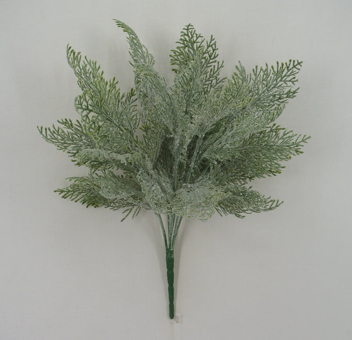 The 18 Long Green Frosted Cypress Bush with 7 Stems 83611 features lifelike green foliage with frosted tips, arranged as a small bouquet and bound at the base, resembling a cypress bush against a plain light background.