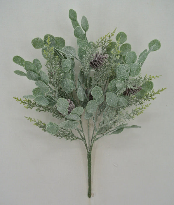 The 19 Green Eucalyptus and Cedar Spray 83662 features green artificial foliage with round, frosted leaves, cedar accents, and pinecones, arranged against a plain white background.