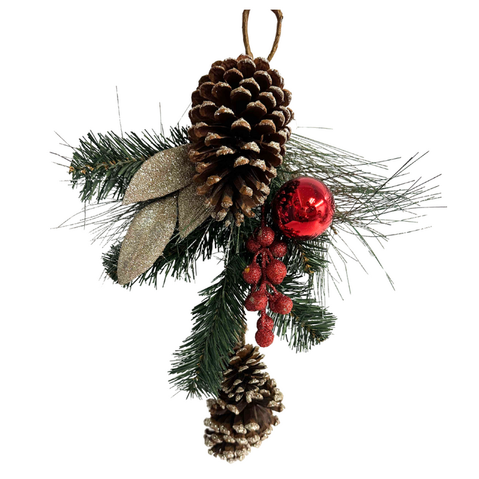 The 15 In Pinecone Ball Hanger 84710 is a festive decoration with pinecones, evergreen branches, glittered red berries, a shiny red ornament, all arranged together and hung by a brown string.
