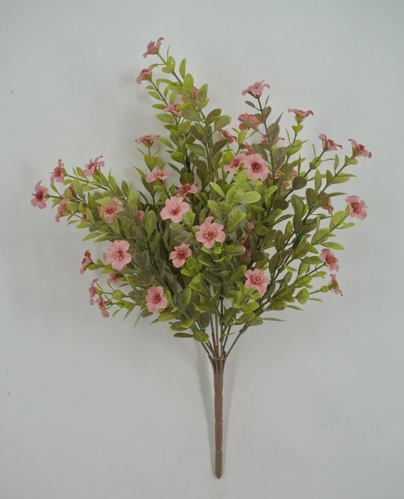 The 16 Mauve Filler Bush (9 Stems, 85152-MV) features artificial green leaves and mauve pink flowers with small blossoms, arranged against a plain white background.