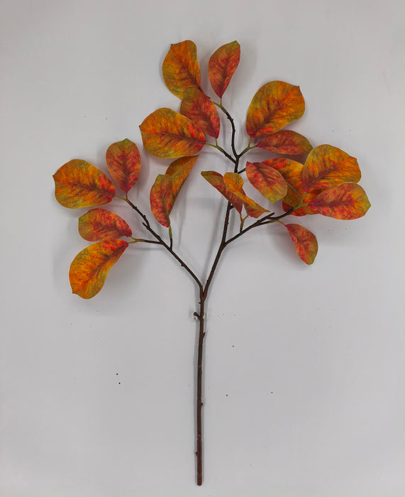 The 39 Long Yellow and Orange Magnolia Leaf Spray (85320-YELOR) features broad, oval-shaped leaves in vibrant orange, yellow, and red hues, beautifully arranged against a plain white background.