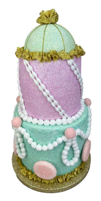 The 13" by 7.5" Pastel Three Tier Cake 86090PASTEL features mint green and pink tiers, gold trim, white pearl garlands, and pink accents for an ornate, whimsical look with charming pastel decoration.