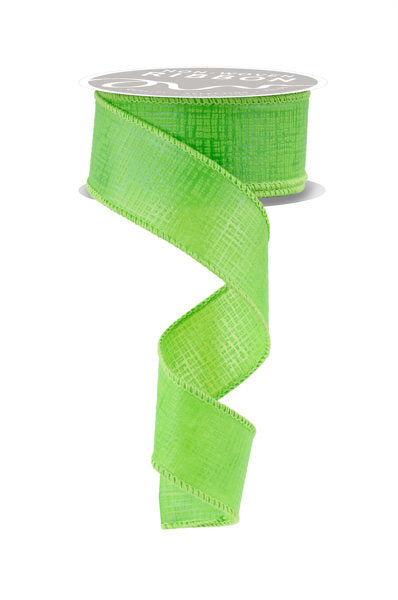 The 1.5X10YD Lime Green Cross Hatch Ribbon (NR100930) unfurls in a spiral, showcasing its vibrant hue and textured appearance with stitched edges. Its simple, light gray top beautifully complements the intricate design for a structured look.