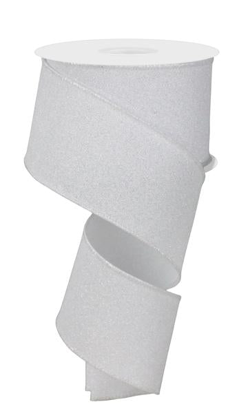 A spool of 2.5 x10yd White Fine Glitter On Faux Royal Ribbon (RGE180127) unfurls in a loose spiral, with the glittery white ribbon hanging down and curving gracefully.