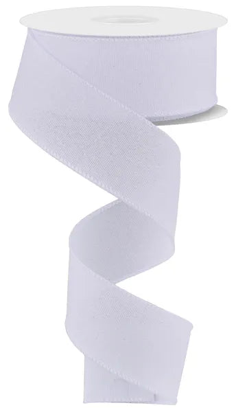 A spool of 1.5X10YD White Crystal Shine Ribbon RGE199427 unwinds in a loose spiral, the shimmering white ribbon hanging down gracefully against a plain background.