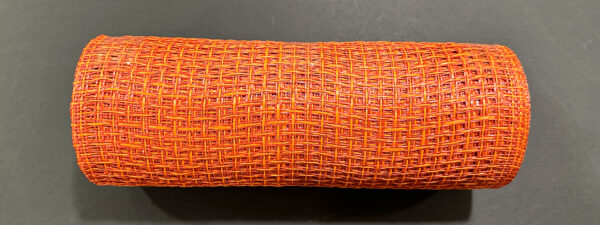 A 10X10Y Rust Orange Textured Weave Mesh (XB253510-31) sits on a dark surface, its intricate pattern and vibrant rust-orange color clearly visible.