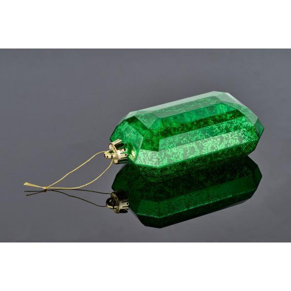The 7 x 4 Green Rectangular Faceted Gem Ornament XJ551506, featuring a gold cap and hanging string, rests elegantly on a reflective black surface.