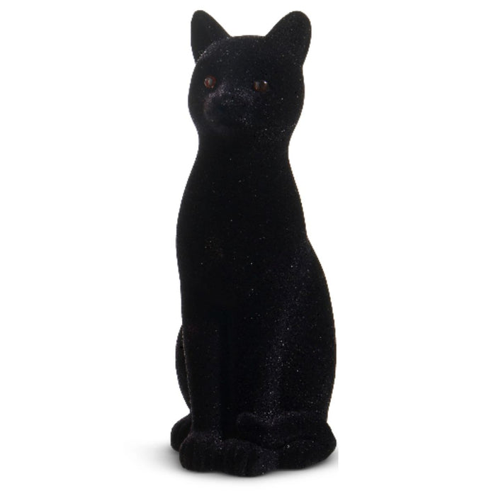 The 11" Flocked Cat 4540848 is a black cat figurine with upright ears and orange eyes, sitting upright against a white background—ideal as a Halloween decoration.