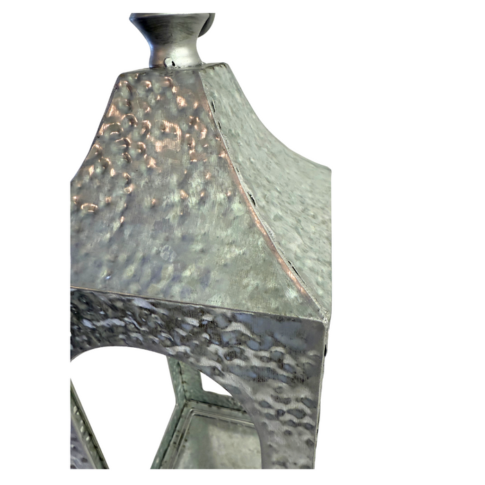 Close-up of our 19 by 7 and 16 by 5 Set of Two Hammered Silver Artisan Lanterns (570600AB), featuring a textured geometric design, shown against a plain white background.