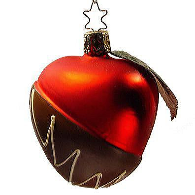 The Chocolate Dipped Candy Apple Christmas Ornament by Inge-Glas of Germany (1-220-08) features a heart-shaped blown glass design with a shiny red top, brown bottom, and white zigzag lines for a festive, candy apple-inspired look.