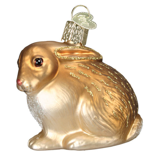 The Tan Cottontail Bunny Ornament by Old World Christmas (12615) is a glass sitting rabbit with glitter accents and a metal loop for hanging—ideal for any Christmas tree.