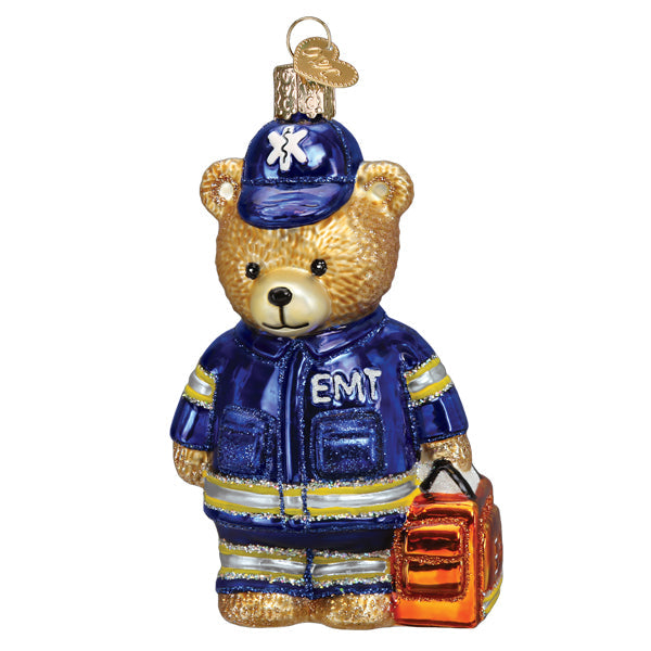 The Emt Teddy Bear Ornament by Old World Christmas (#12648) features a teddy bear EMT in a blue uniform with an orange medical bag and gold hanging loop—perfect as a gift or ornament for emergency medical technicians.