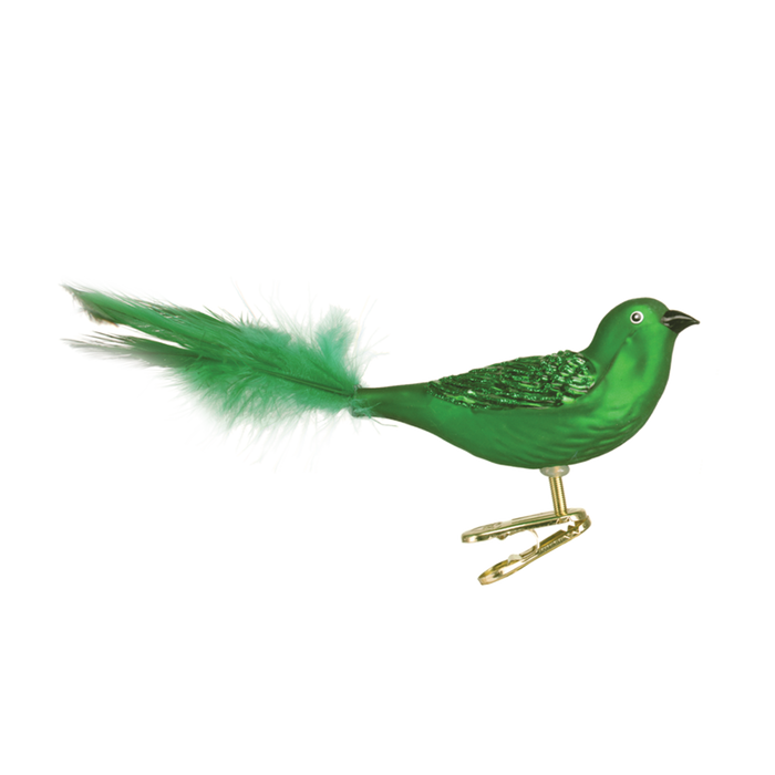 The Brilliant Songbird 18011 Old World Christmas Ornament features a glossy green body, textured wings, feathered tail, and a gold clip for easy attachment. This charming glass ornament comes assorted, shown on a plain white background.