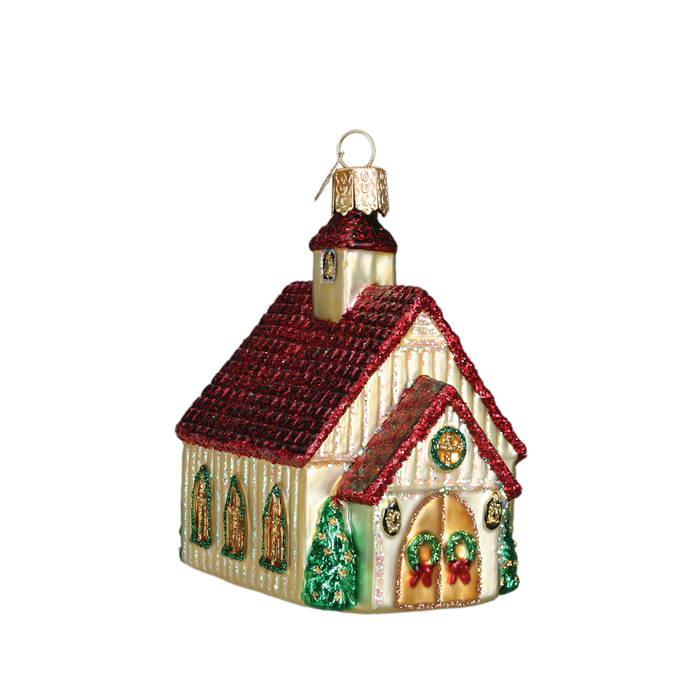 The Christmas Chapel Ornament Old World Christmas Ornament 20063 features a small church with a red roof, gold walls, green trees, and festive wreaths—perfect for holiday décor. Isolated on a white background.