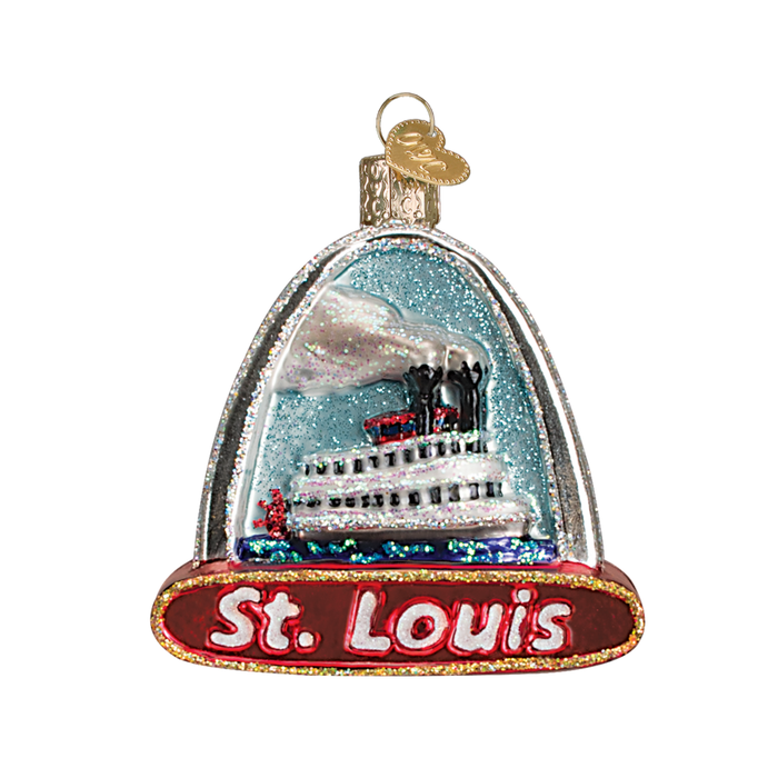 The St. Louis Arch 20073 Old World Christmas Ornament features a white riverboat with steam stacks inside a glittery glass dome, “St. Louis” in bold red and white at the base, and the Arch subtly displayed in the background.