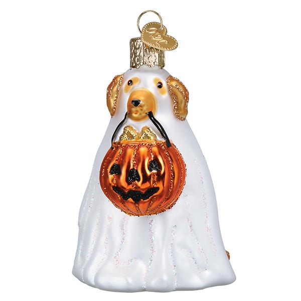 The Trick Or Treat Pooch Ornament Old World Christmas Ornament 26088 is a glass dog dressed as a ghost, holding an orange pumpkin bucket with gold and brown accents and a gold hanging loop—perfect for Halloween décor.