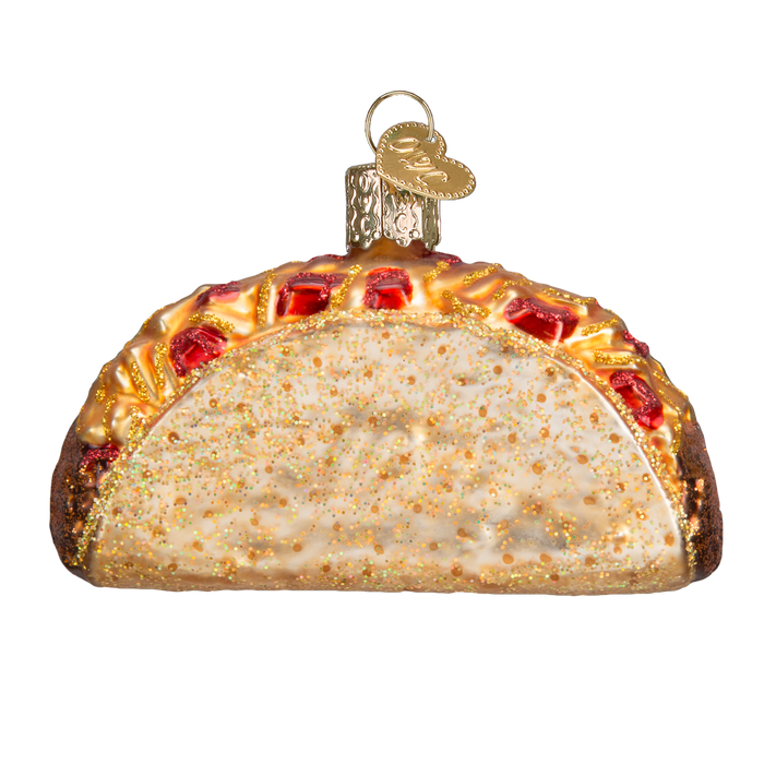 The Taco Ornament (Old World Christmas 32084) features gold accents, red and yellow details like Mexican food toppings, and a gold cap with loop for hanging.