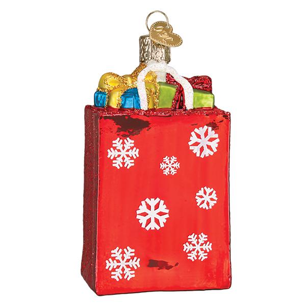 Add festive cheer to your decor with the Holiday Shopping Bag Ornament Old World Christmas Ornament 32396—a shiny red gift bag adorned with white snowflakes, colorful presents, white handles, and a gold hanging loop.