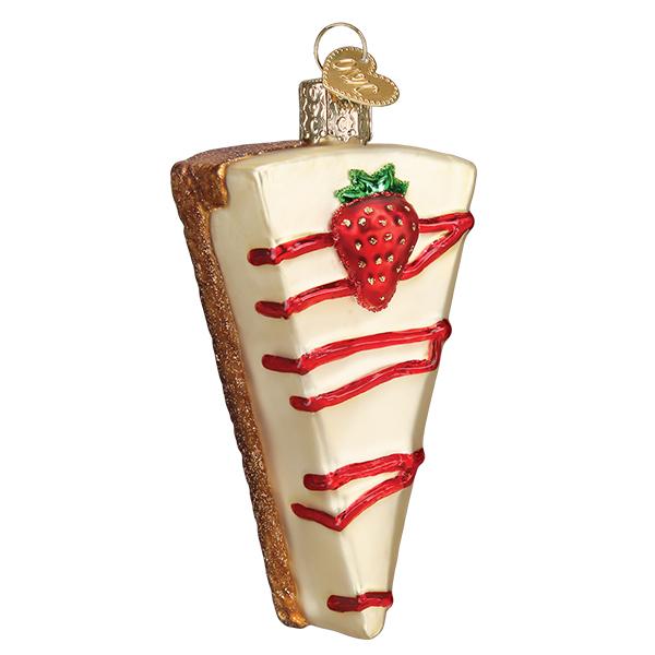 The Cheesecake Old World Christmas Ornament 32429 is a mouth-blown glass piece featuring a strawberry on top and red glaze drizzle, complete with a gold cap for hanging. It beautifully captures the sweet essence of the holidays.
