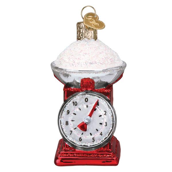 The Kitchen Scale Old World Christmas Ornament 32485 features a shiny red and silver design with a sparkling white bowl, gold hanging loop, and visible front dial—a glittery gift perfect for bakers.