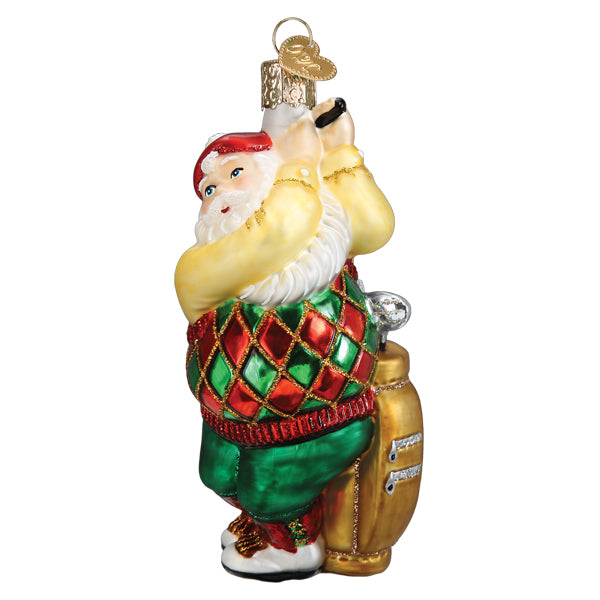 The Golfing Santa Ornament by Old World Christmas (Product 40329) depicts Santa Claus decked out in a vibrant golf ensemble, featuring a red and green argyle sweater, green pants, and white shoes. Ready to hit the links, he holds his trusted golf club next to a finely crafted golf bag.