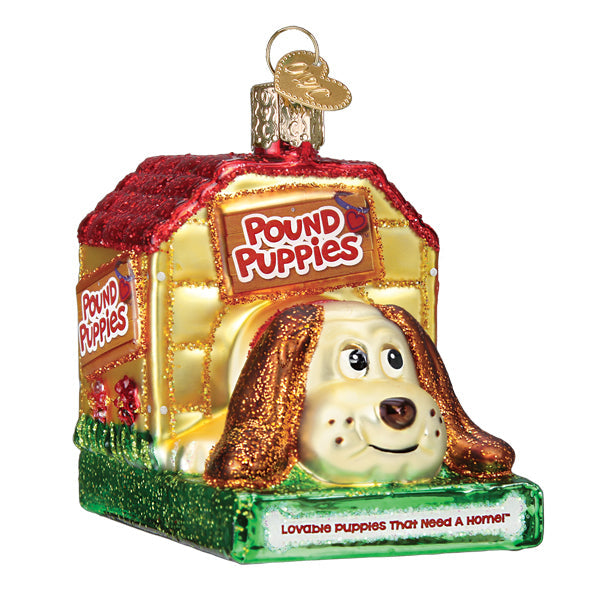 The Pound Puppies Ornament Old World Ornament 44187 is a glittery doghouse with Pound Puppies signs, featuring a smiling brown-and-white dog and the phrase “Lovable puppies that need a home!” on the base.