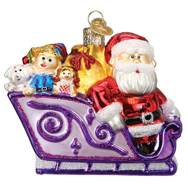 The Santa And Friends Ornament by Old World Christmas (44205) features Santa in a purple sleigh with toys, glittery accents, and festive colors, capturing Rudolph’s holiday magic.