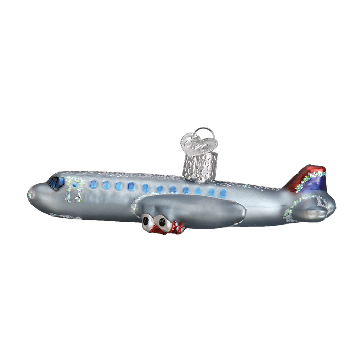 The Passenger Plane Ornament Old World Christmas Ornament 46065 features silver body, blue windows, red and blue tail accents, and a top loop for hanging—perfect for adding festive aviation charm to your tree.