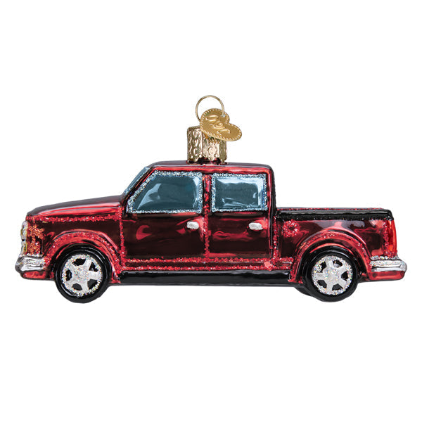 The Pickup Truck Ornament by Old World Christmas (46107) features a shiny red finish, silver accents, black tires, and a gold hanging loop on top, set against a white background.