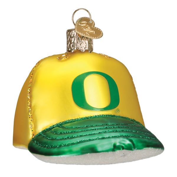 The Oregon Baseball Cap Ornament by Old World Christmas (#63719) is a yellow and green glass ornament featuring a large green O for the University of Oregon and comes with a gold loop for hanging.
