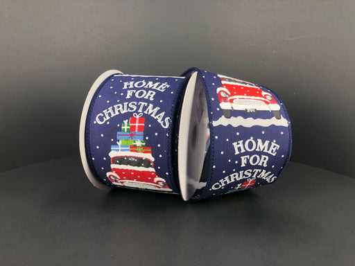 The Navy Satin/Home For Christmas Car ribbon, 2.5 x 10Y, features a festive design of a red car with gifts on a snowy backdrop and Home for Christmas printed in white with snowflakes, adding charm to holiday decor.