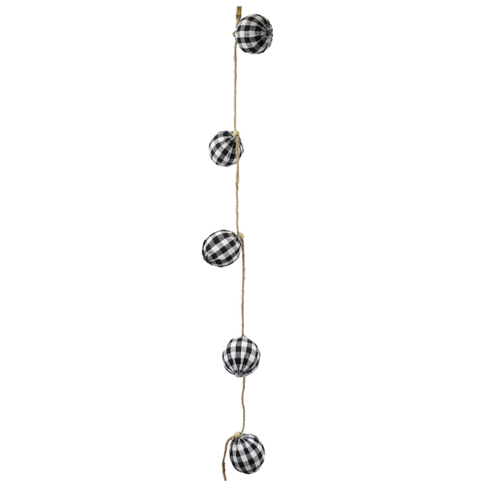 The 5' Black White Check Fabric Ball Garland (84760GINGHAM) features five evenly spaced, checkered fabric balls on twine for a classic decorative touch.