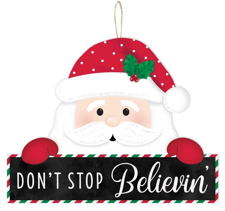 The 12.75L x 10H Don’t Stop Believin Sign (AP8908) features a cartoon Santa with red hat and gloves, holding a sign on a black background. Red, green, and white stripes border this MDF festive piece.