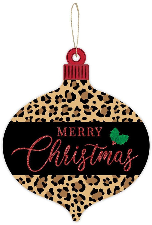 The 12"H X 10"L Merry Christmas/Leopard Ornament in black, white, brown, tan, and red (AP8961) features "Merry Christmas" elegantly displayed in bold red glittery letters. Accompanying the festive message is a delightful green holly decoration that adds an extra bit of charm.