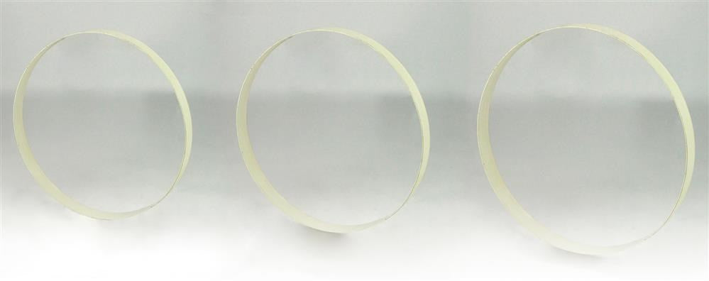 Three thin, pale yellow S/3 9.75-12"Dia Metal Wreath Rings in Antique White (MD0684K6) stand upright on a white surface with a light gray background, evenly spaced and symmetrical.