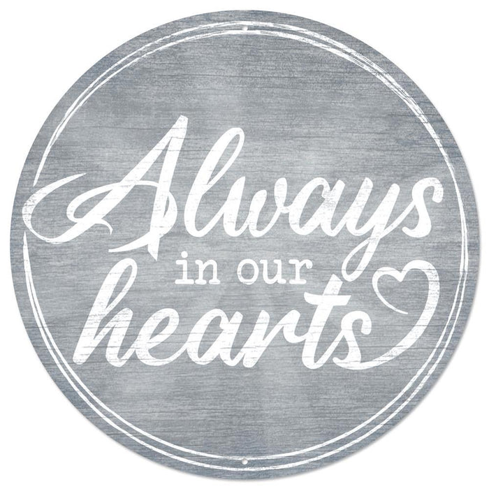 The 12Dia Metal Always In Our Hearts Sign in smoke blue and white (MD1005) features elegant script text with a heart shape—a beautiful, heartfelt memorial for any space.